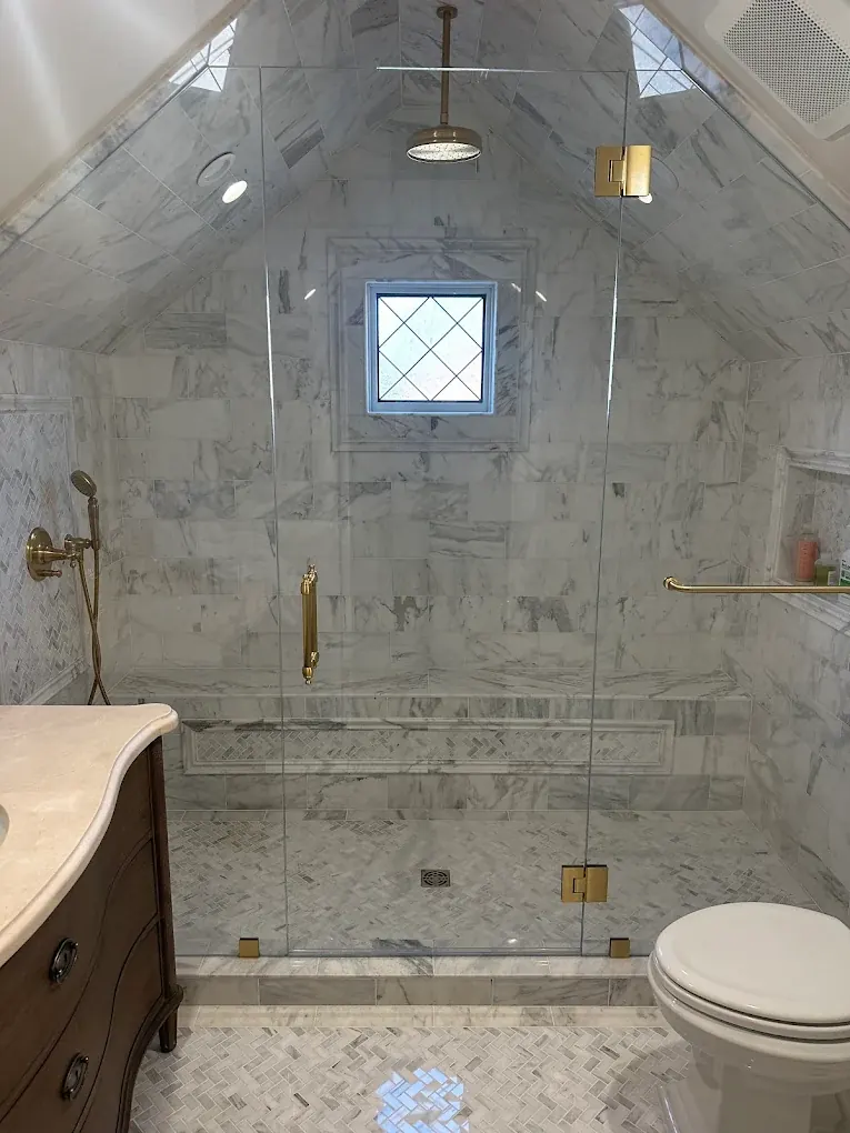 Marble shower fitted under a sloped ceiling
